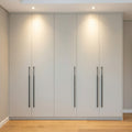 Light Grey Matte Five-Door Floor-to-Ceiling Wardrobe with Long Black Handles and Recessed Spotlights